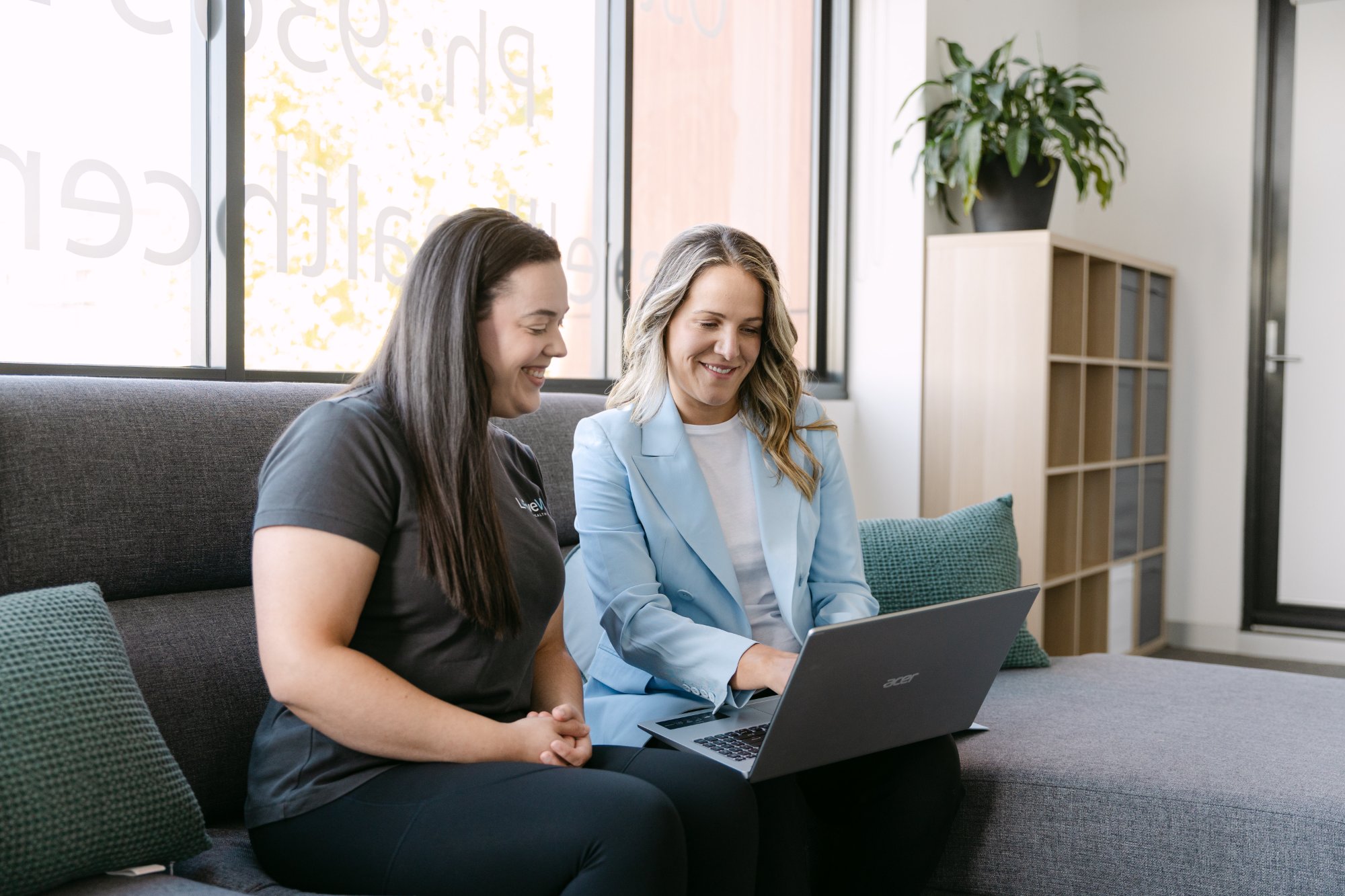 Live Well practitioner and health professional reviewing patient referral information on laptop