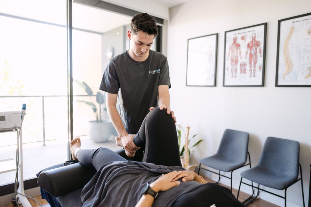 Dr Liam Franks performing knee and lower leg mobilisation for patellar tendinopathy at Live Well Health Centre