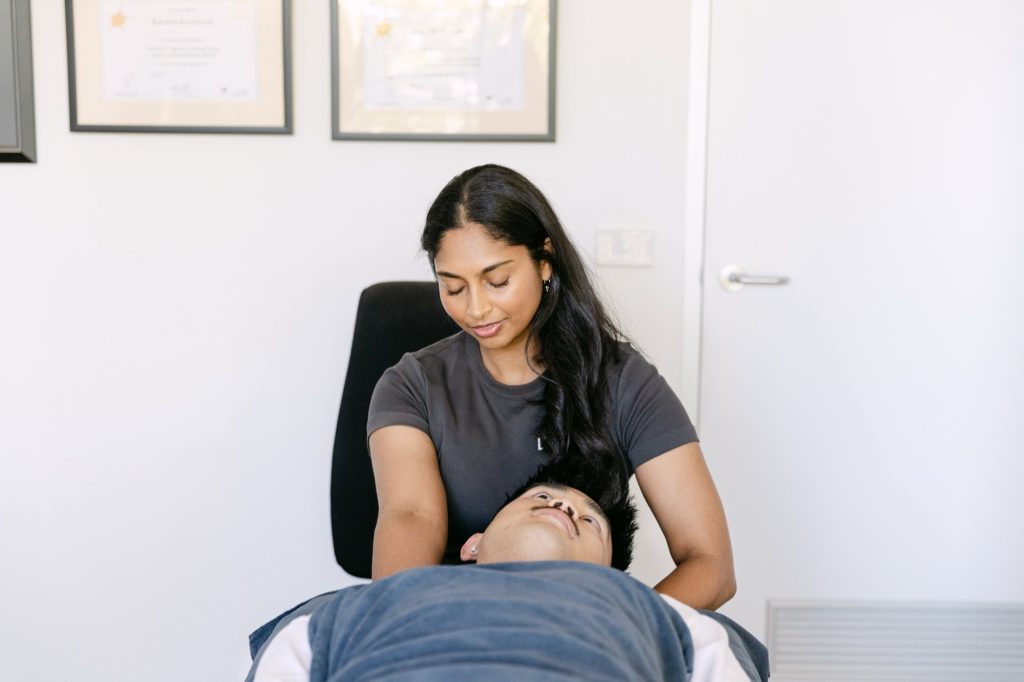 Live Well practitioner performing gentle cranial and cervical osteopathic treatment for thoracic outlet syndrome