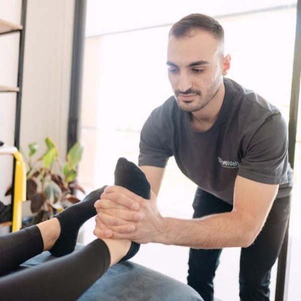 Live Well osteopath performing hands-on foot mobilisation to treat plantar fasciitis in clinic